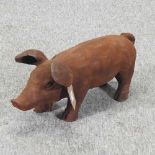 A rusted metal model of a pig
