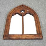 A Gothic style oak framed wall mirror,