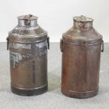 A pair of metal milk churns