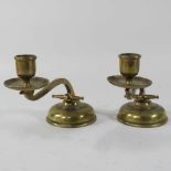 A pair of early 20th century Arts and Crafts brass candle holders,