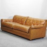 A tan leather upholstered sofa.