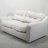 A modern beige upholstered sofa,