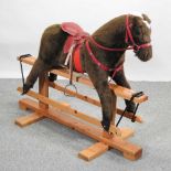 A mid 20th century upholstered rocking horse,