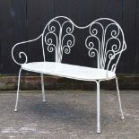 A white painted metal garden bench