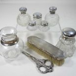 A collection of silver mounted glass scent bottles