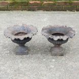 A pair of black painted cast iron garden planters