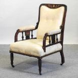 An Edwardian cream upholstered armchair