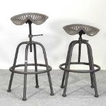 A pair of metal tractor seat stools