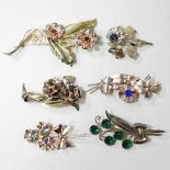 A collection of six American brooches