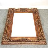 An ornate gilt framed wall mirror