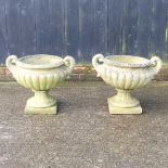 A pair of reconstituted stone garden planters