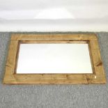 A rustic wooden framed wall mirror