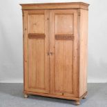 An antique pine double wardrobe