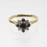 An 18 carat gold sapphire and diamond cluster ring