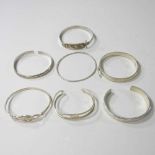 A collection of silver and white metal bangles