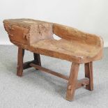 A rustic driftwood reclaimed wooden bench