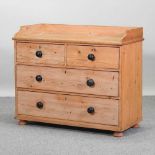 An antique pine chest of drawers