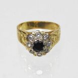 An 18 carat gold diamond and sapphire cluster ring