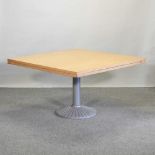 A modern single pedestal dining table