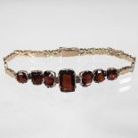 An unmarked gold and garnet bracelet