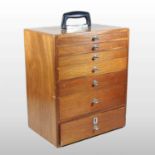 A mid 20th century teak dentist's cabinet