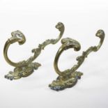 A pair of 19th century ornate brass wig hooks