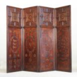 An early 20th century oak and embossed leather four fold screen