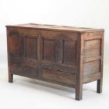 An 18th century panelled oak mule chest