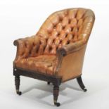 A George IV leather button back library armchair
