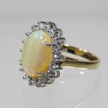 An 18 carat gold opal and diamond cluster ring