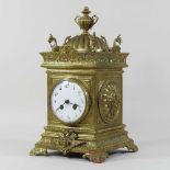 An ornate brass cased mantel clock
