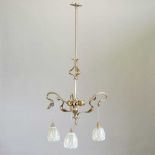 An Arts and Crafts brass three branch ceiling light