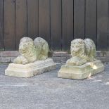 A pair of reconstituted stone garden models of lions