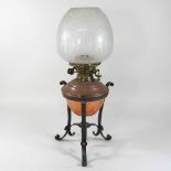 An early 20th century copper and brass oil lamp and shade