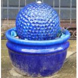 A blue glazed stoneware garden fountain