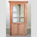 A George III stripped pine standing corner cupboard