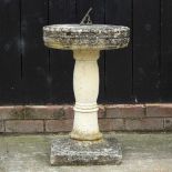 A reconstituted stone sun dial