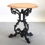 A Victorian style black painted cast iron bistro table