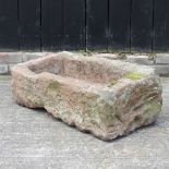 A large carved stone trough
