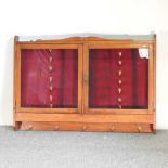 An early 20th century walnut horse livery cabinet