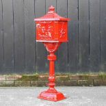 A red painted metal letter box