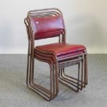A set of four metal stacking chairs