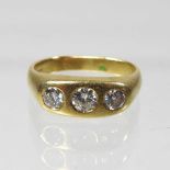 An 18 carat gold three stone diamond ring