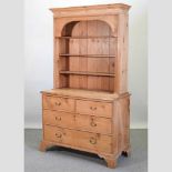 An antique pine bookcase on chest