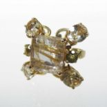 An unmarked rutilated quartz seven stone cluster ring