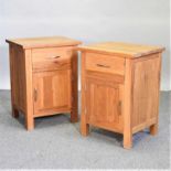 A pair of modern light oak bedside cabinets