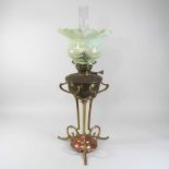 An Arts and Crafts copper and brass oil lamp