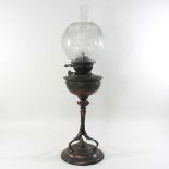 An Arts and Crafts copper oil lamp and shade