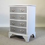 A grey painted serpentine bedside chest