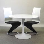 A contemporary white circular dining table